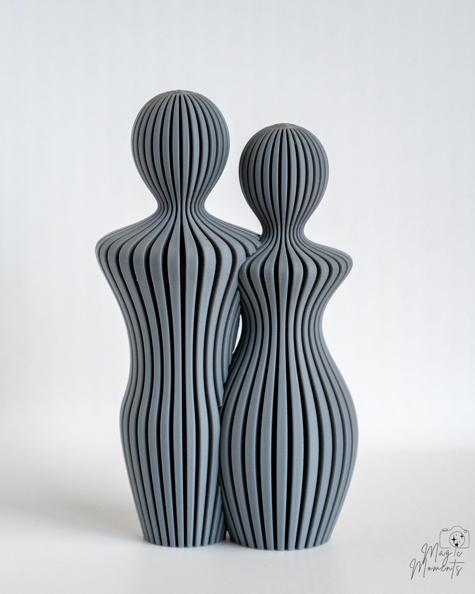 Grey abstract couple sculpture pair with flowing textured design