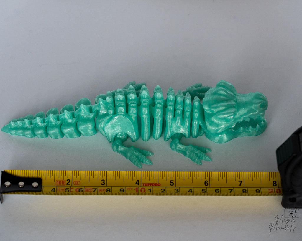crocodile figure next to measuring tape for scale