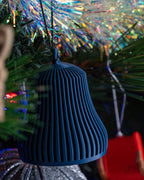 blue ribbed christmas bell ornament hanging on christmas tree