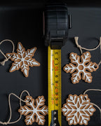 Snowflake ornament set next to measuring tape for scale