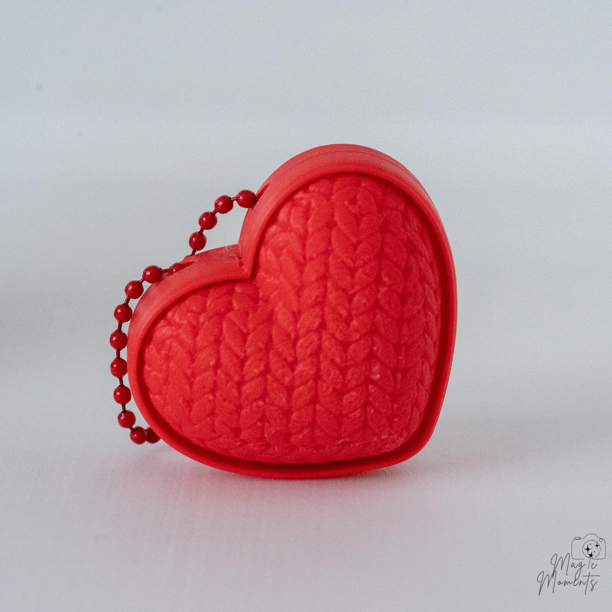 Heart clicker with hanging loop and textured design