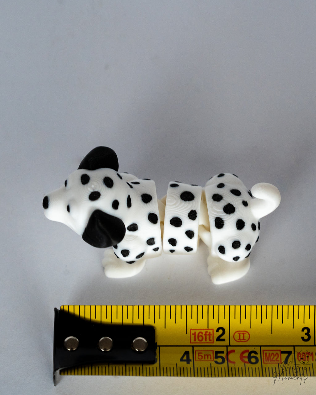 dalmatian figurine next to measuring tape for scale