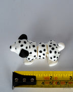 dalmatian figurine next to measuring tape for scale