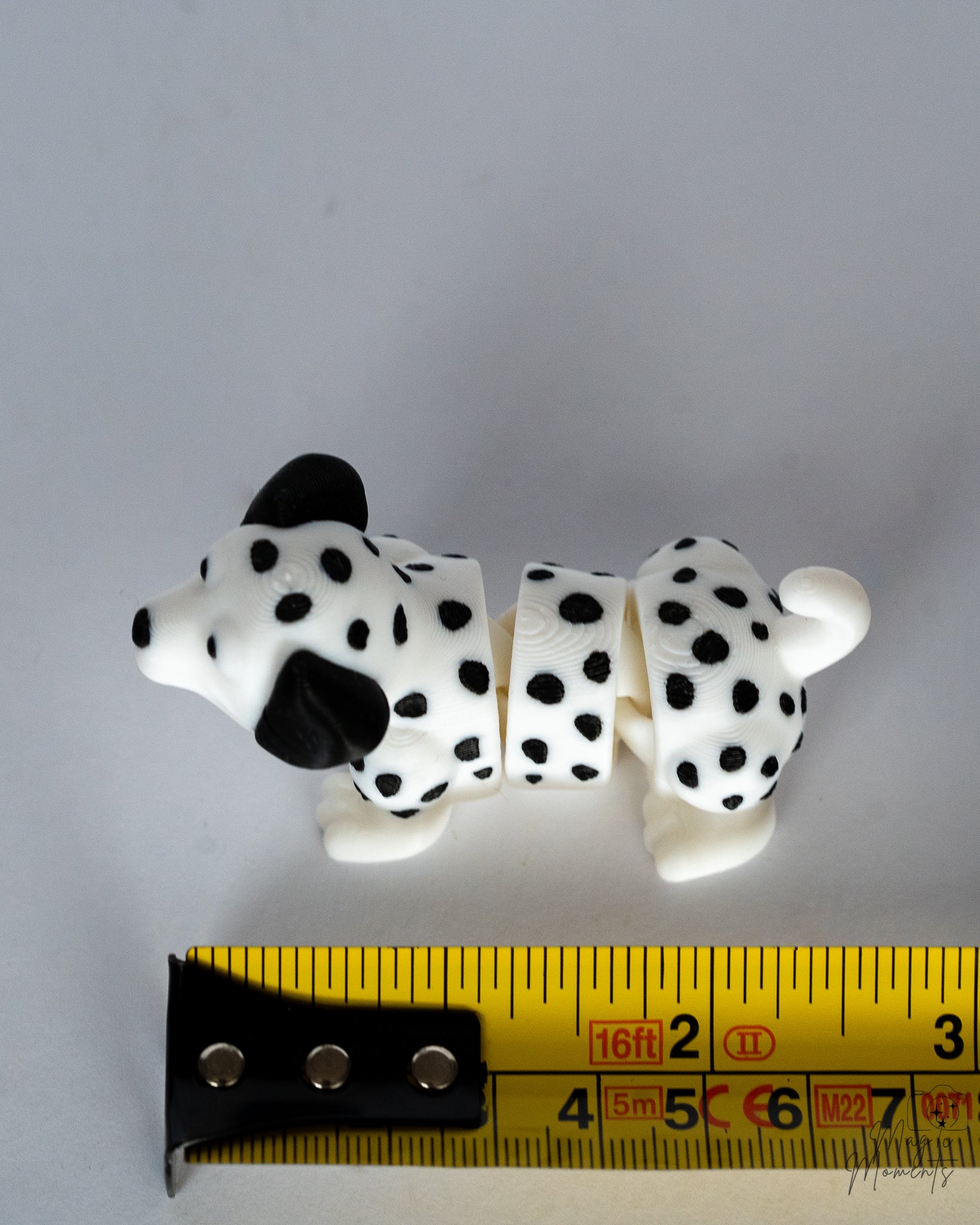 dalmatian figurine next to measuring tape for scale