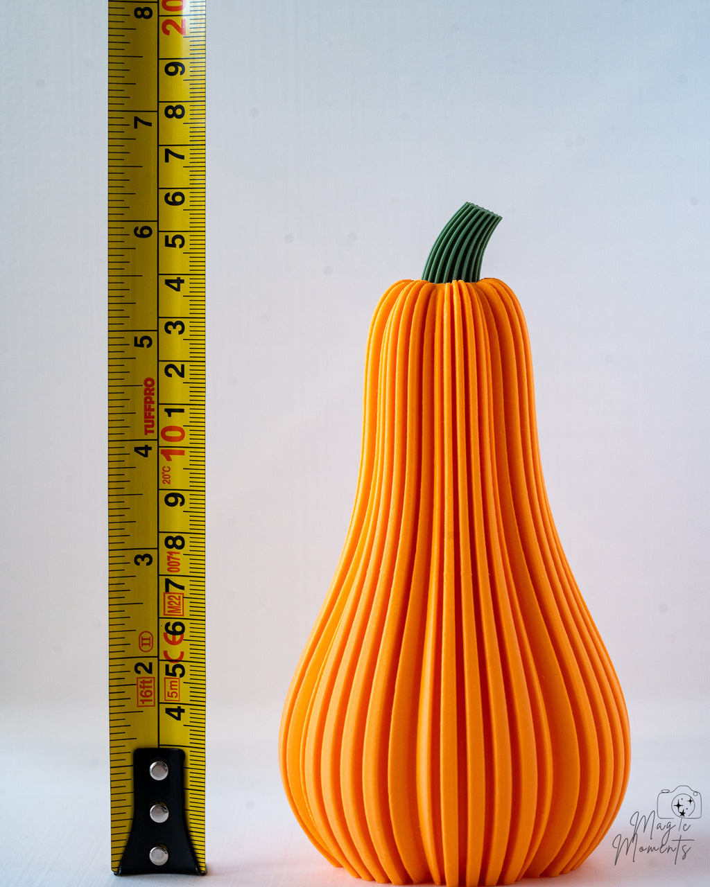 orange butternut squash next to measuring tape for scale