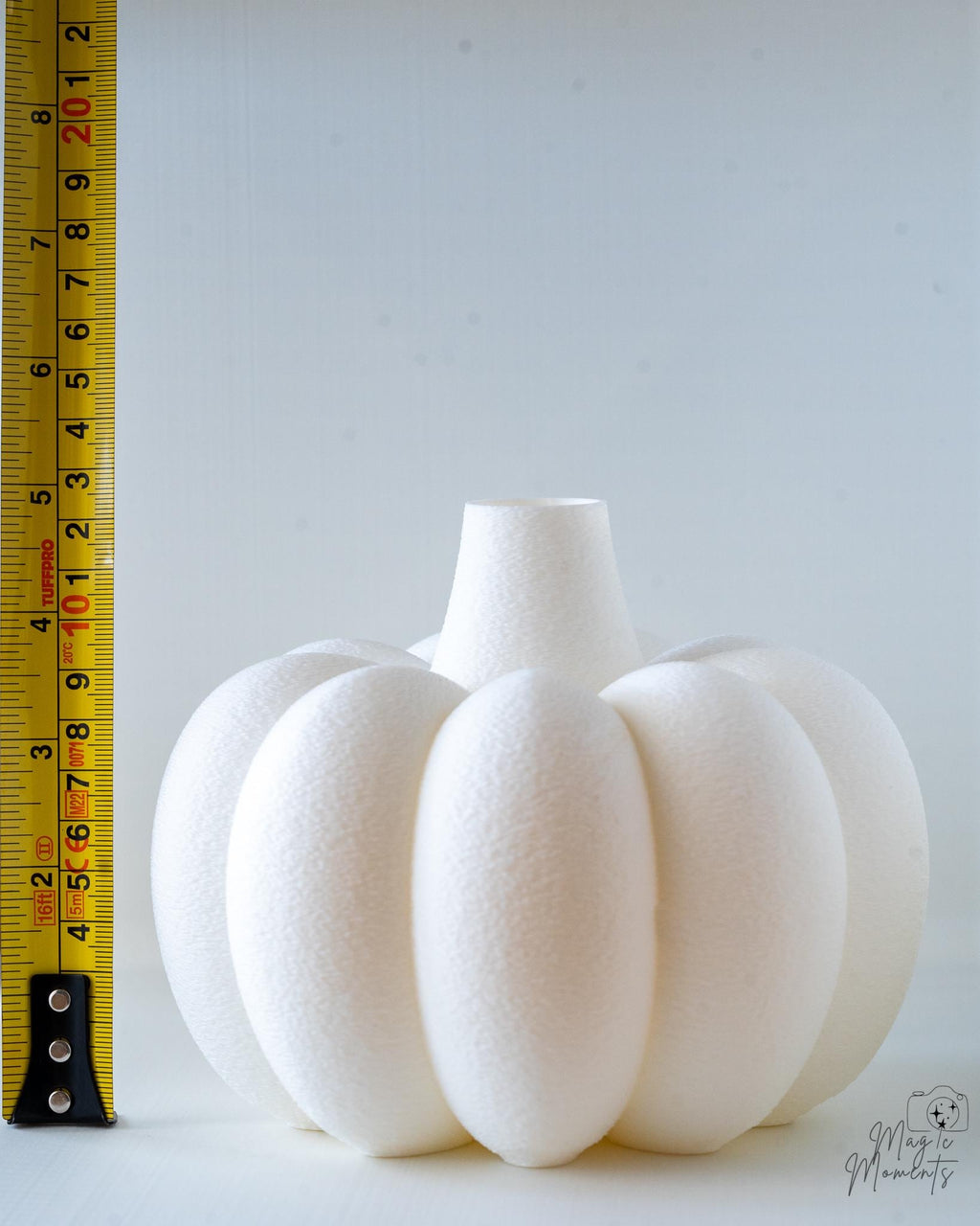 pumpkin vase next to measuring tape for scale