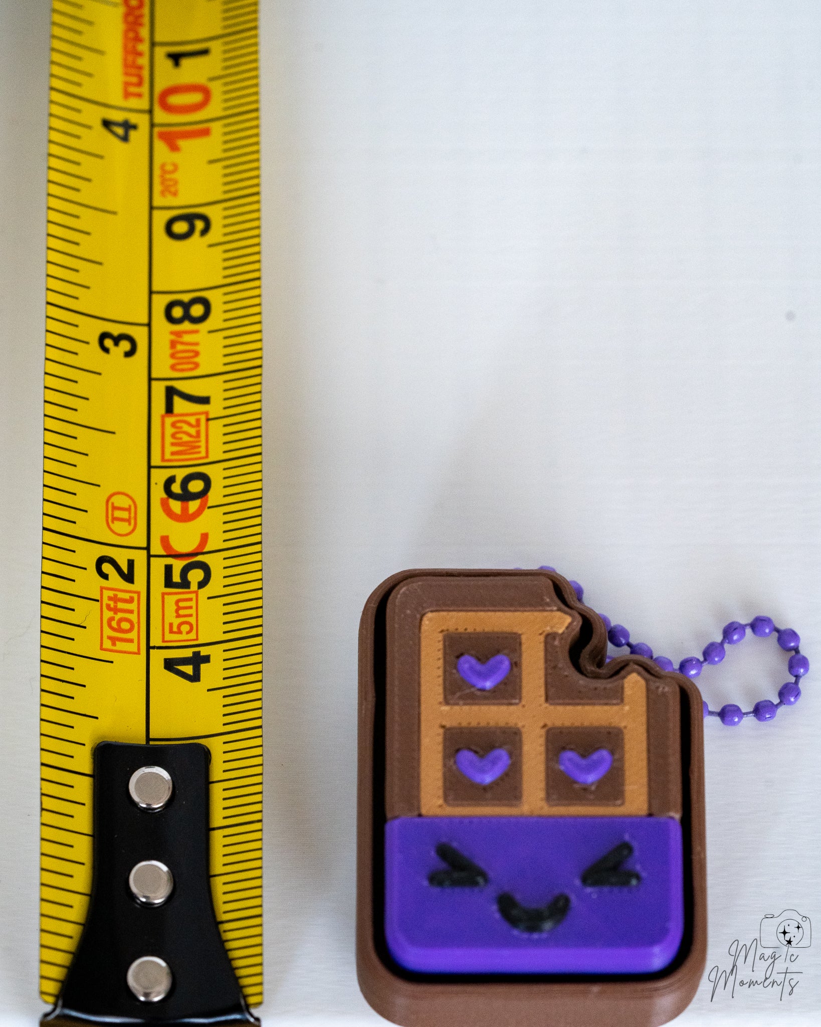 haunted chocolate clicker next to measuring tape for scale