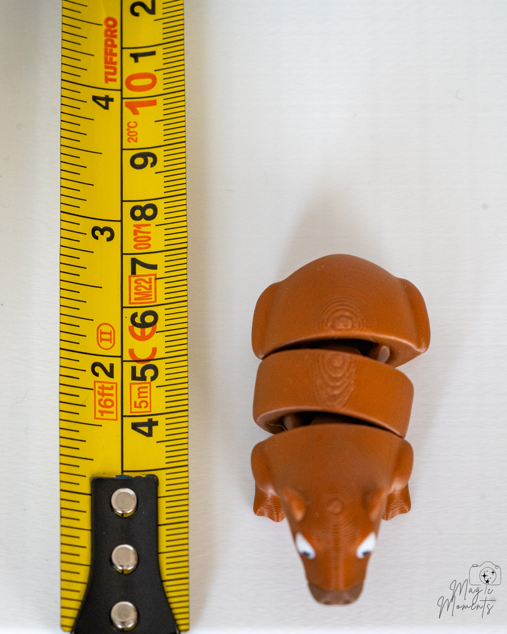Capybara figure next to measuring tape for scale