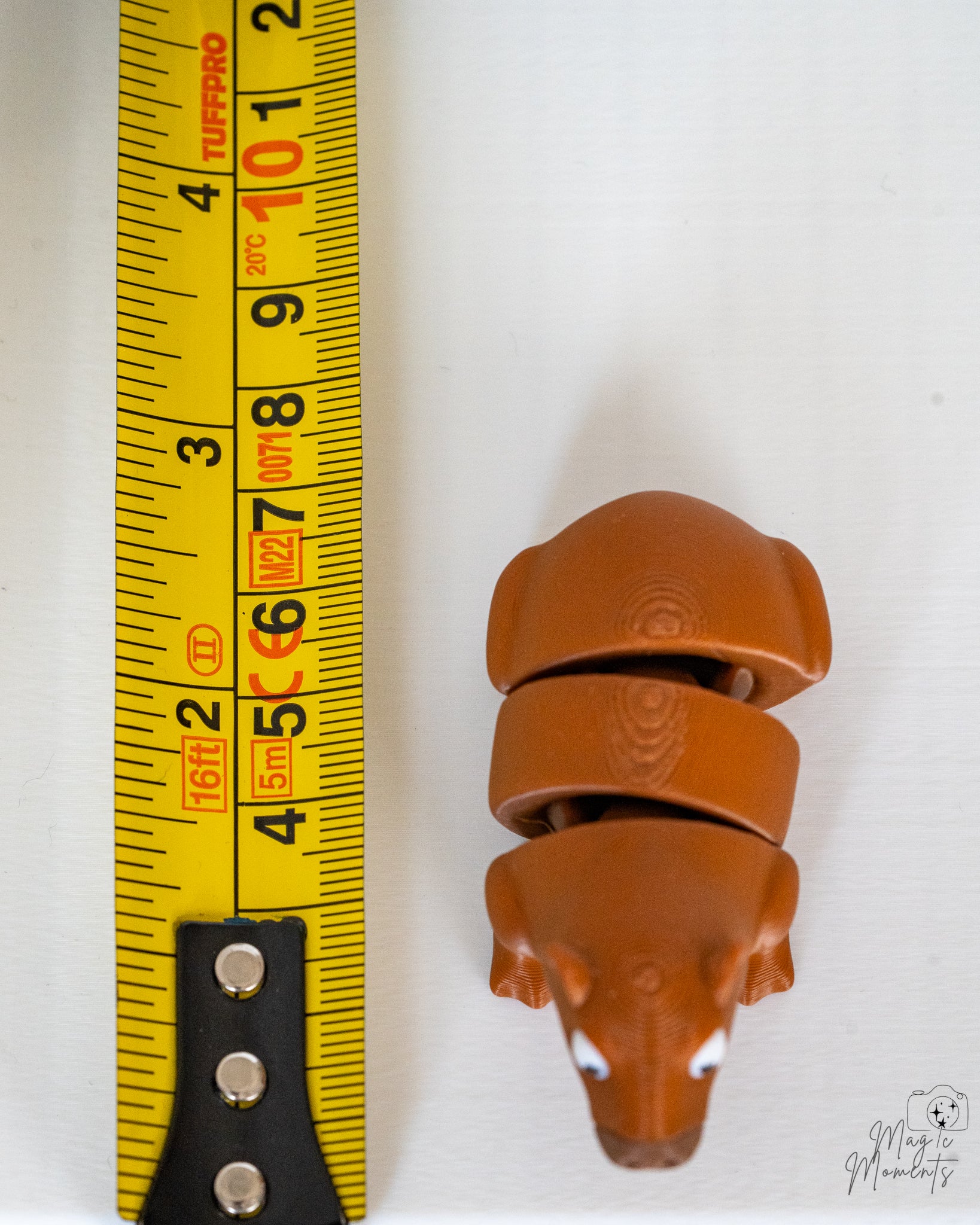 Capybara figure next to measuring tape for scale