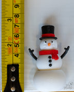 snowman next to measuring tape for scale