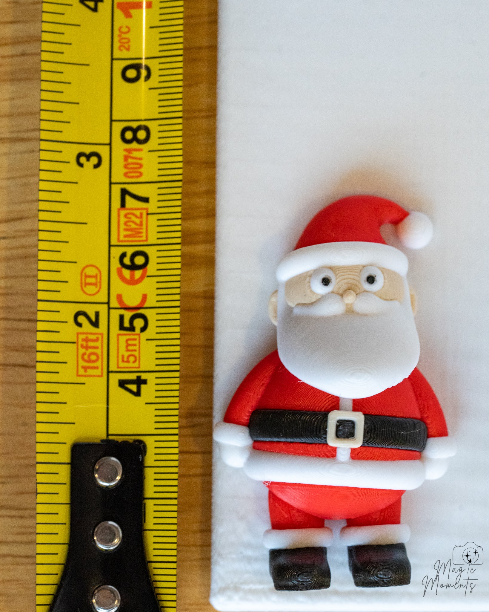 santa claus next to measuring tape for scale