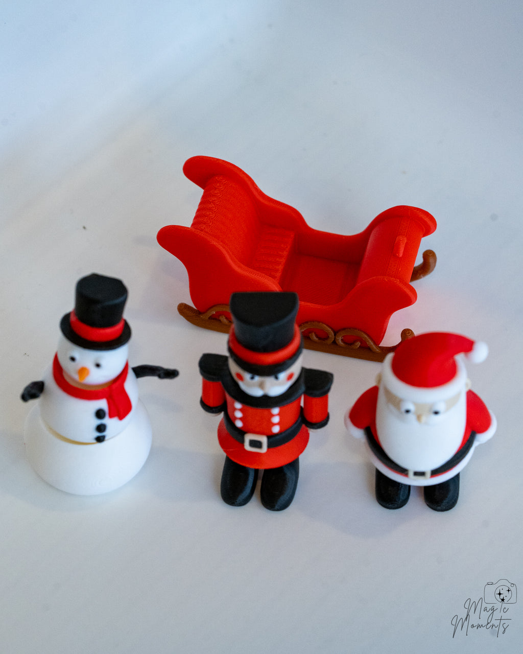 Christmas-themed figurines including a snowman, soldier, and Santa Claus on a white background.