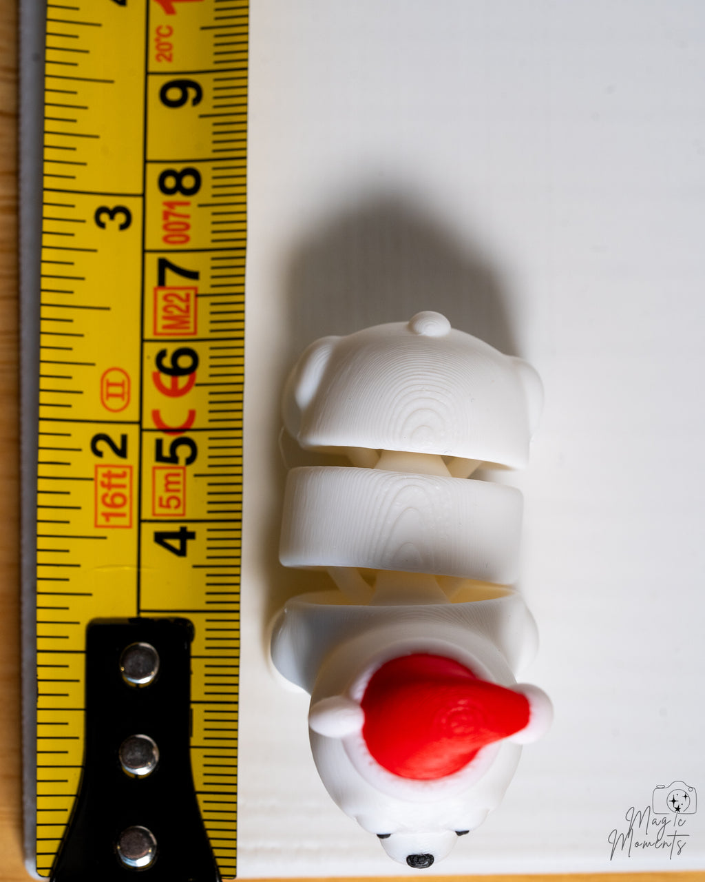 polar bear next to measuring tape for scale