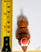 dachshund wearing a Santa hat  with a measuring tape on a white background