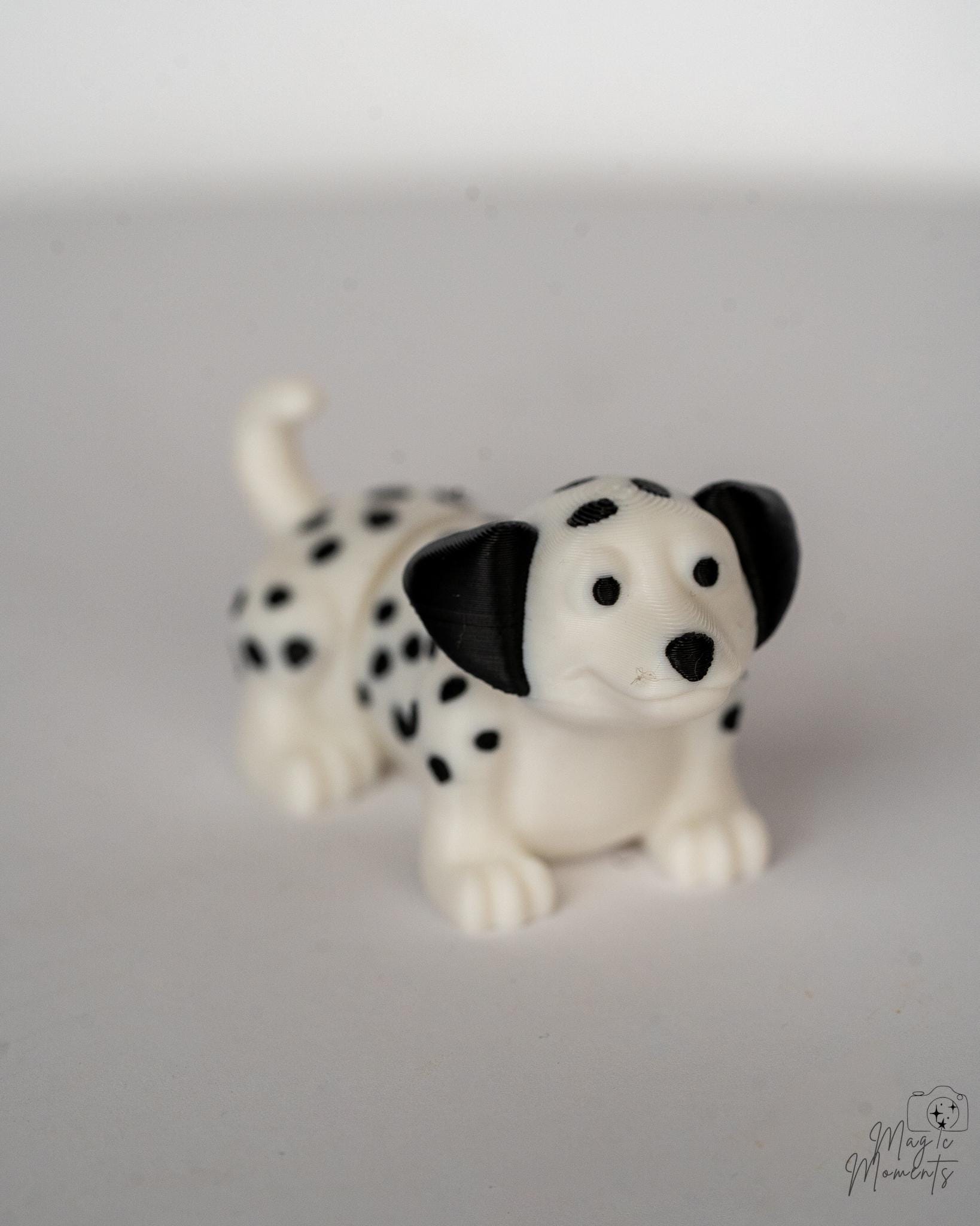 Dalmatian puppy figure with black spots and cute expression