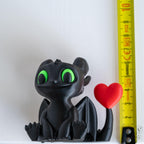 dragon figurine next to measuring tape for scale