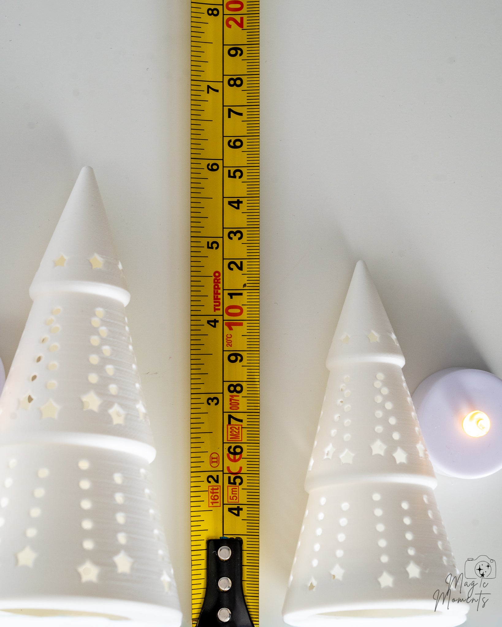 white christmas trees next to measuring tape for scale