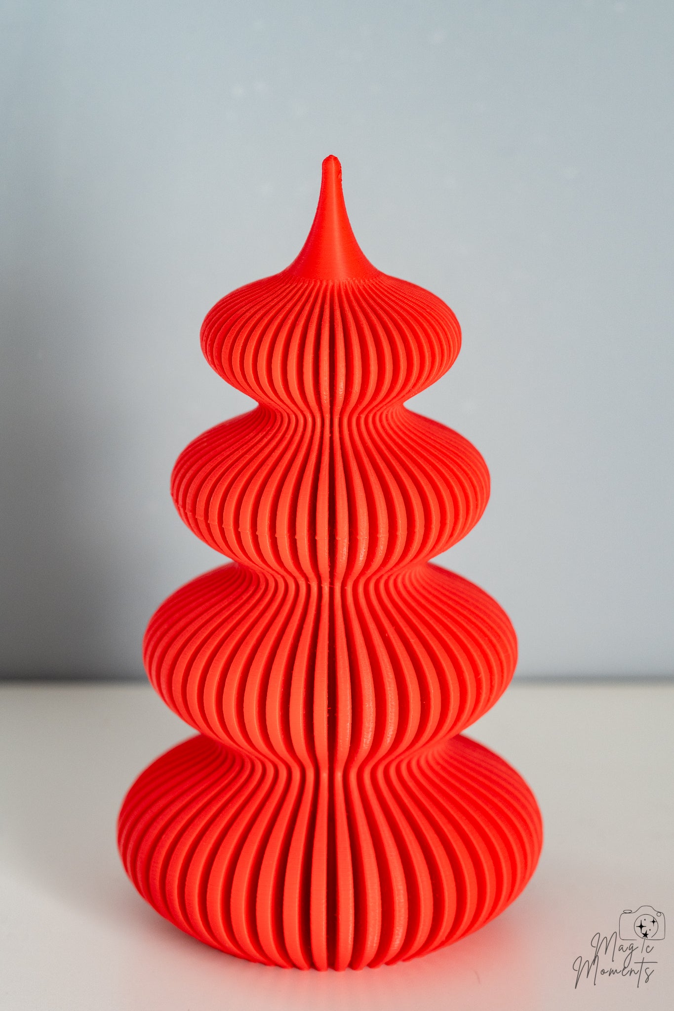 Red spiral Christmas tree decoration with ribbed layered texture