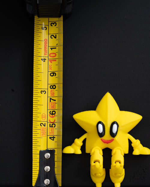 Star shelf sitter next to measuring tape for scale