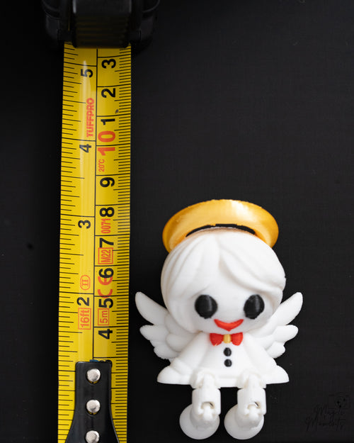 Angel shelf sitter next to measuring tape for scale