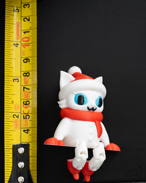 Christmas cat shelf sitter next to measuring tape for scale