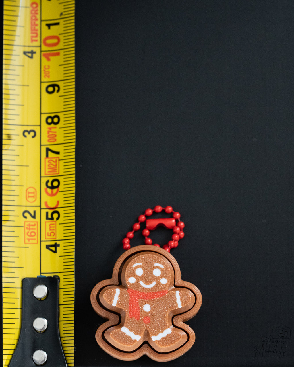 Gingerbread clicker next to measuring tape for scale