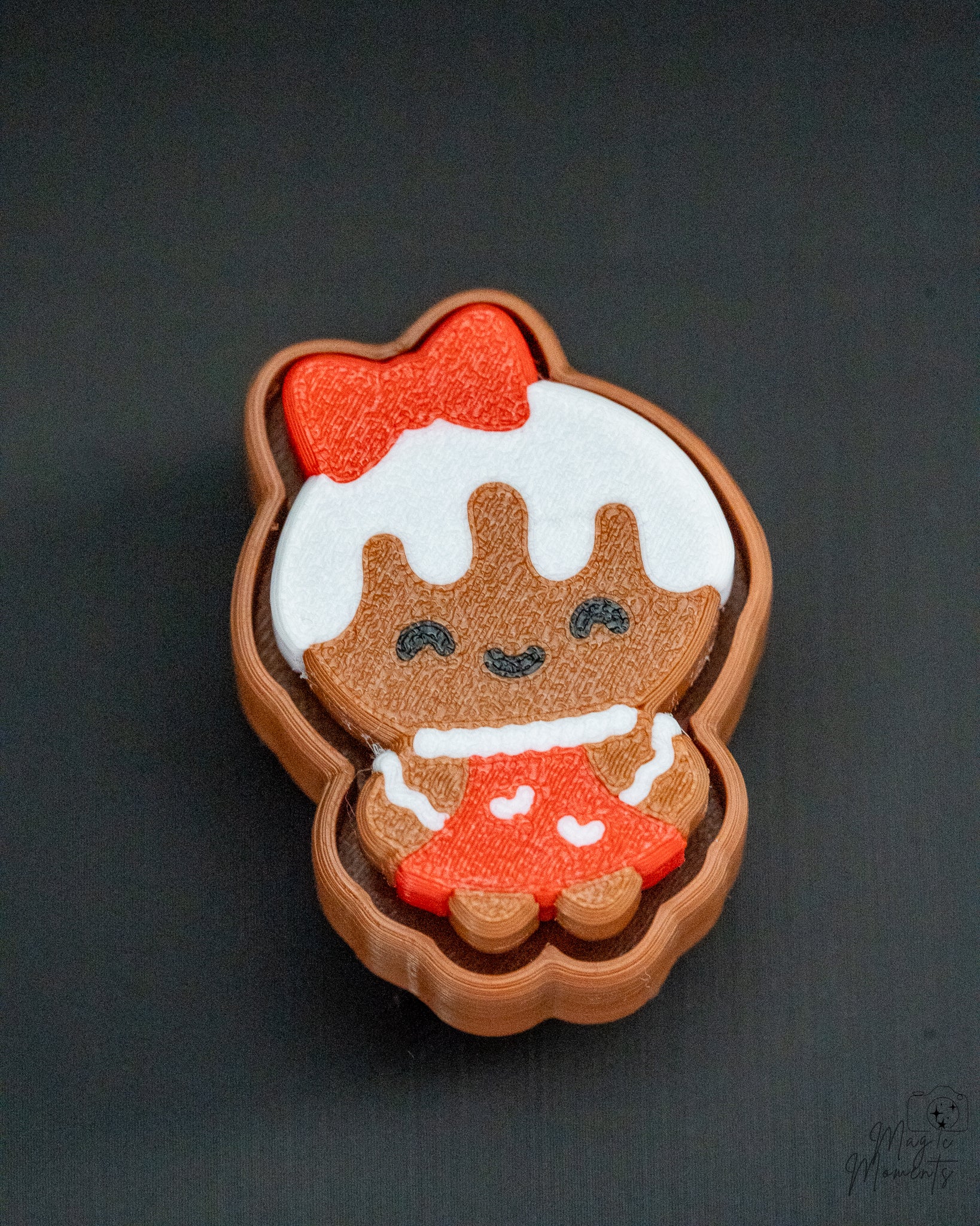 Gingerbread girl clicker with red bow and festive cookie style finish