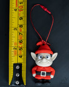 Santa elf ornament next to measuring tape for scale
