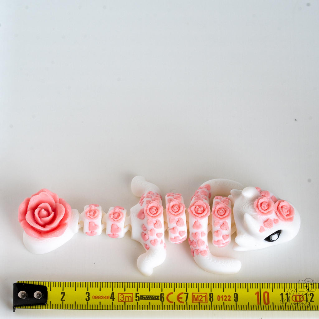 rose dragon next to measuring tape for scale