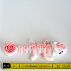 rose dragon next to measuring tape for scale