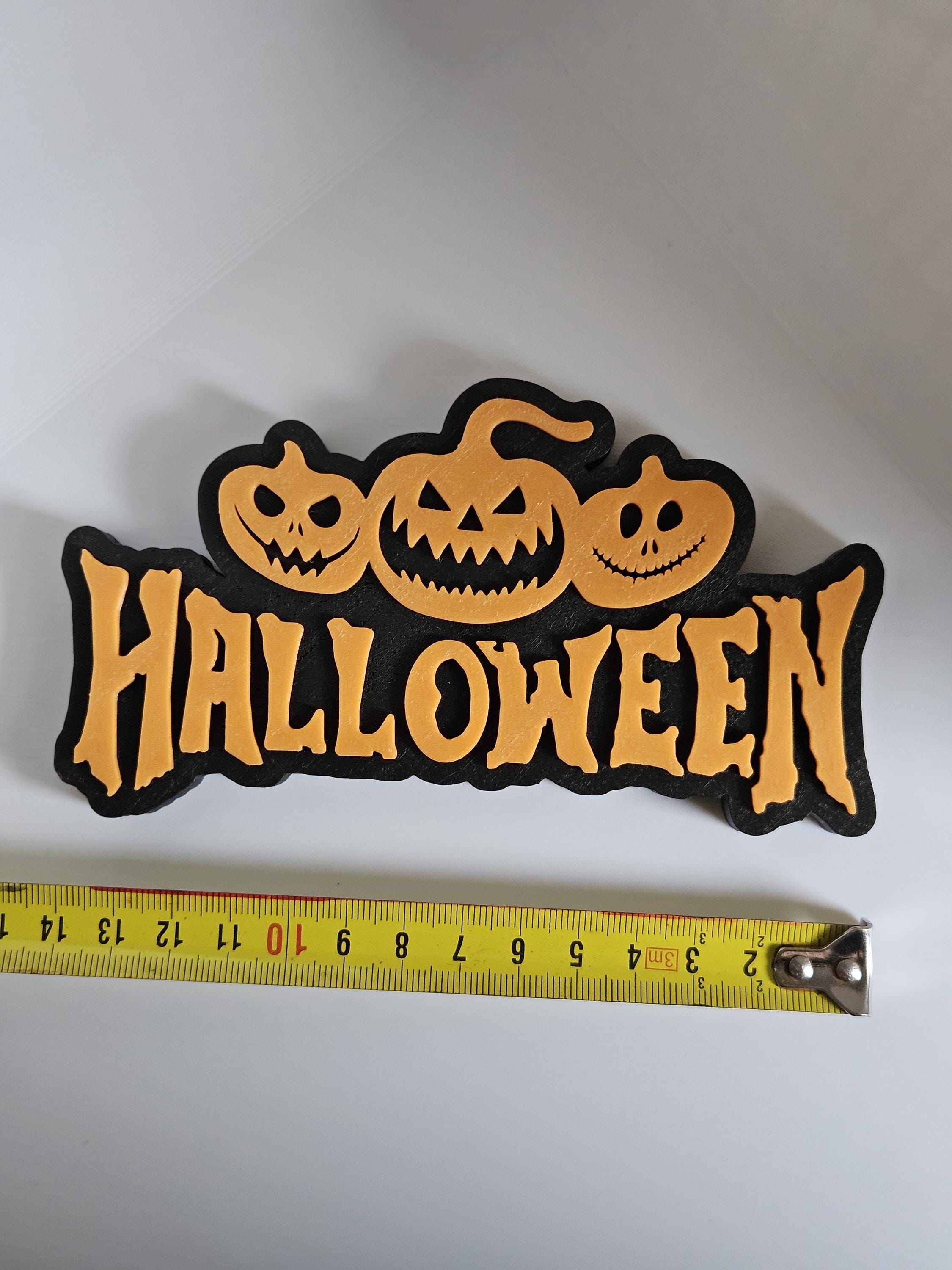 Halloween shelf decoration next to measuring tape for scale