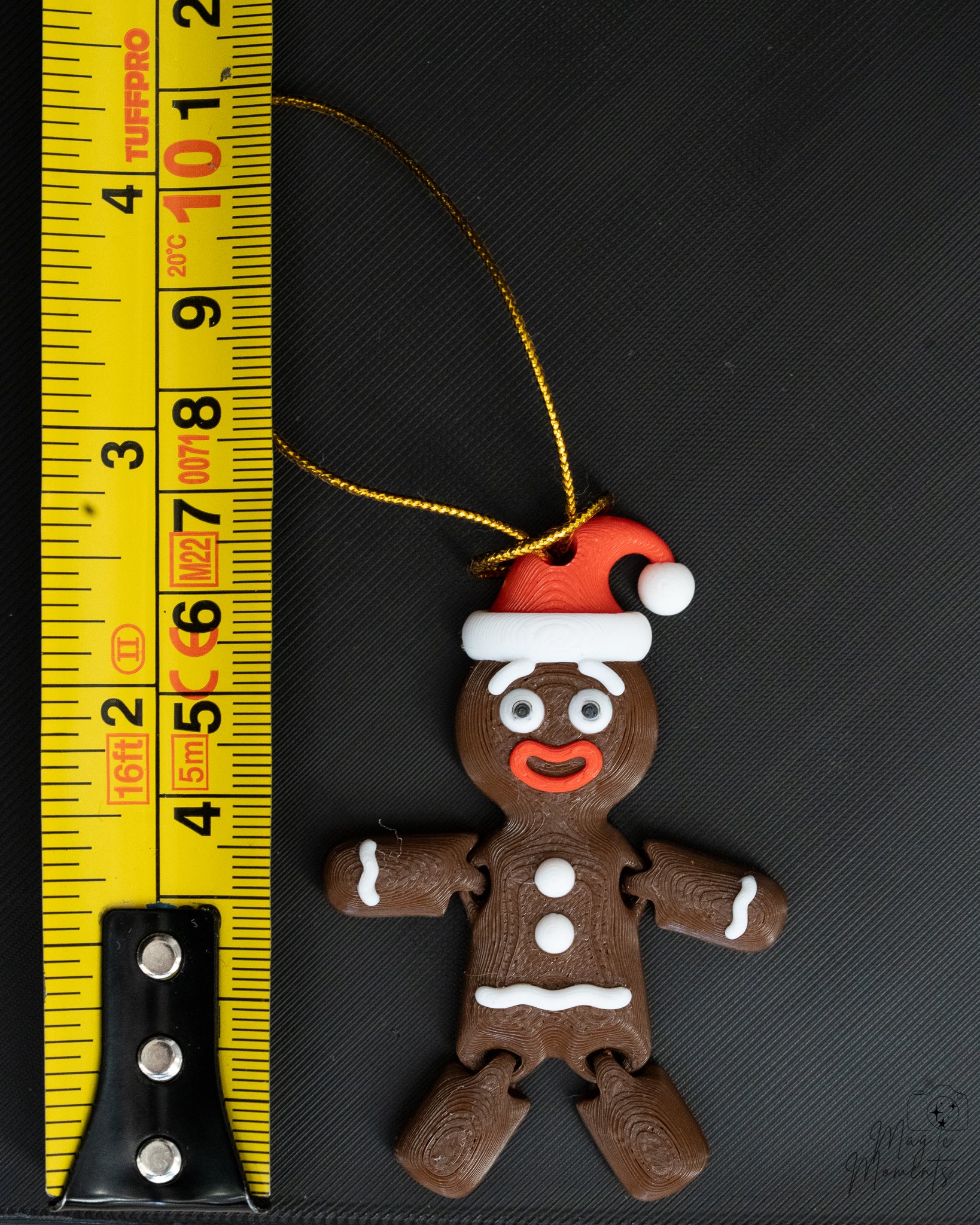 Gingerbread Christmas ornament next to measuring tape for scale