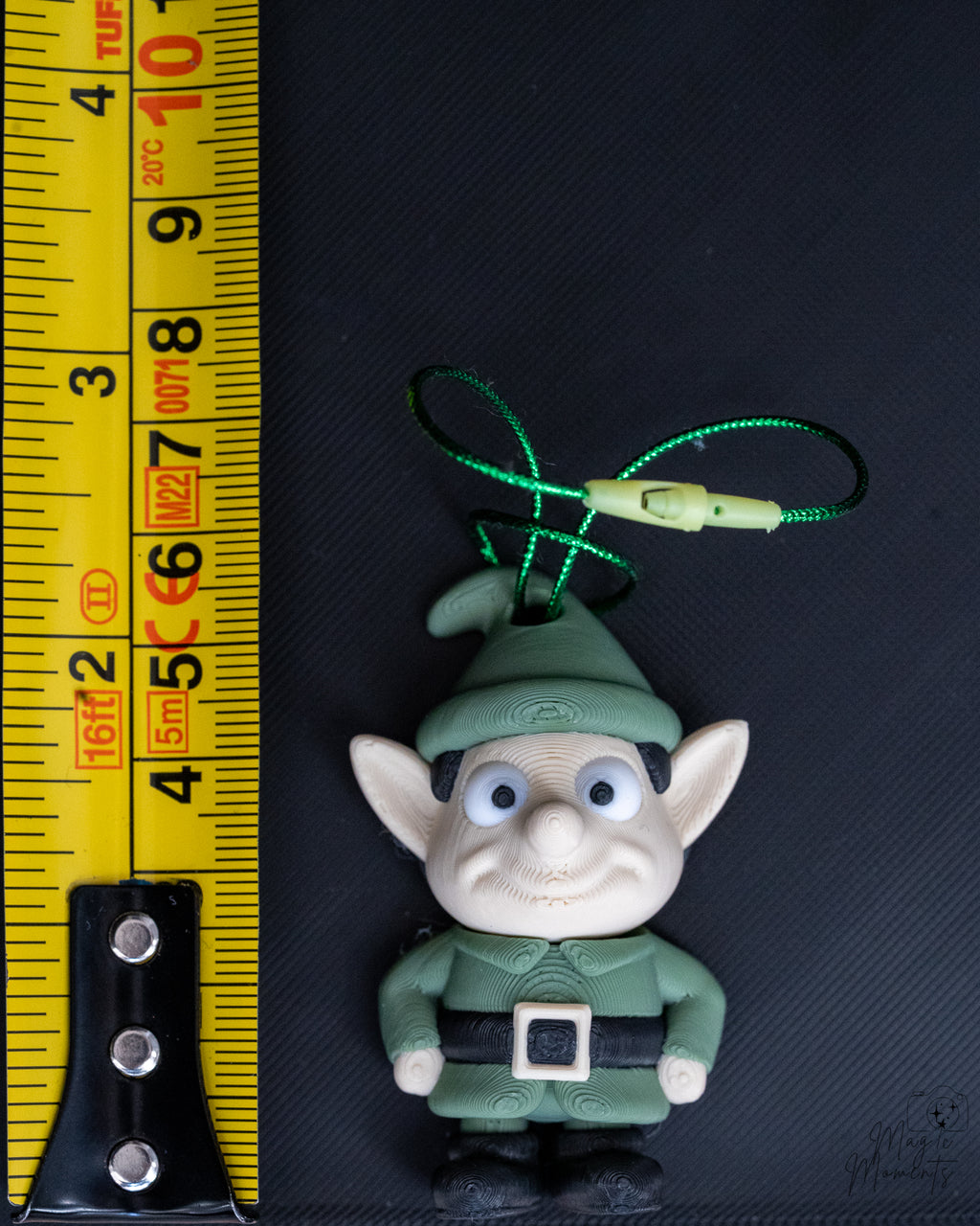 Elf ornament next to measuring tape for scale