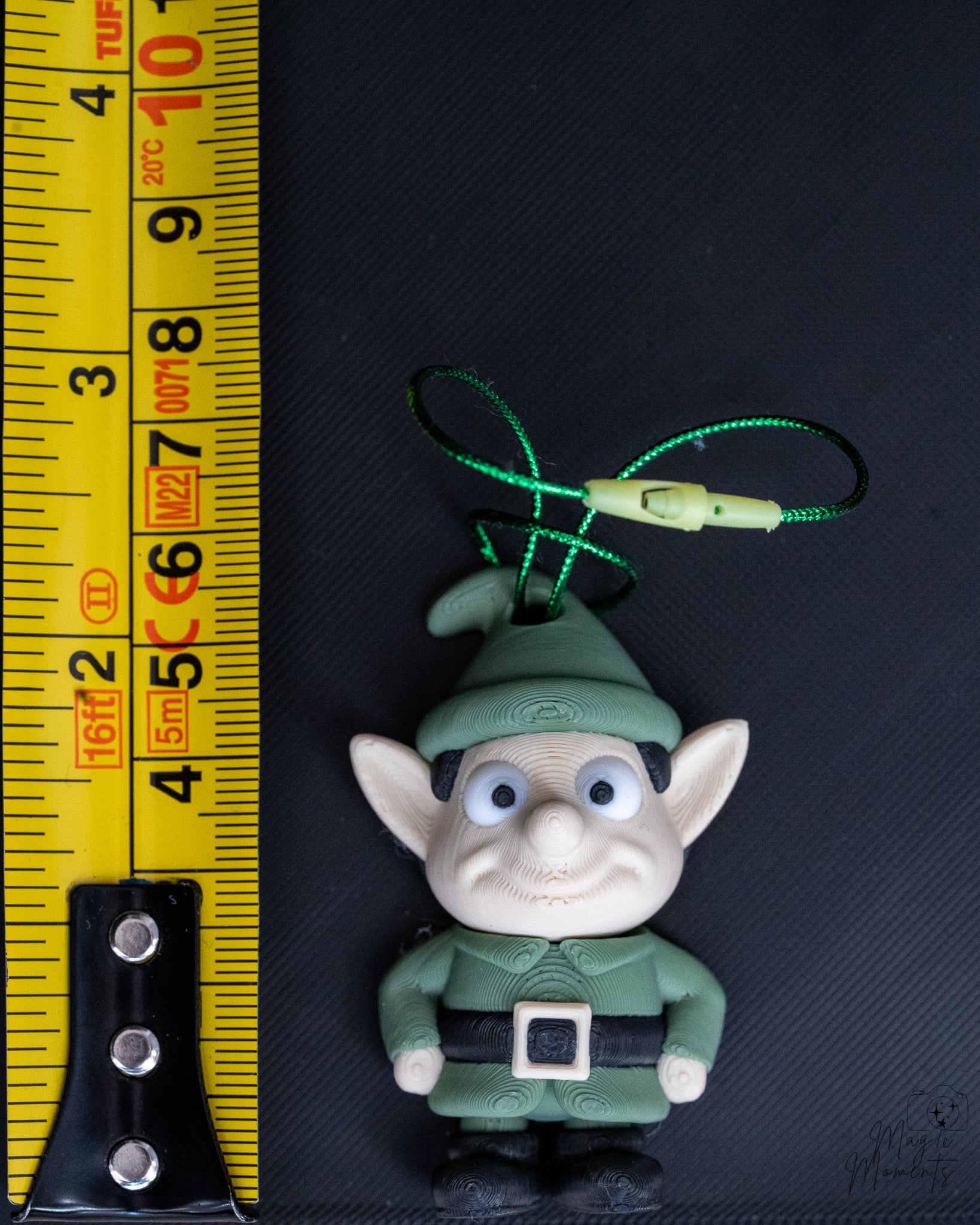 Elf ornament next to measuring tape for scale