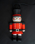 Nutcracker Christmas ornament next to measuring tape for scale