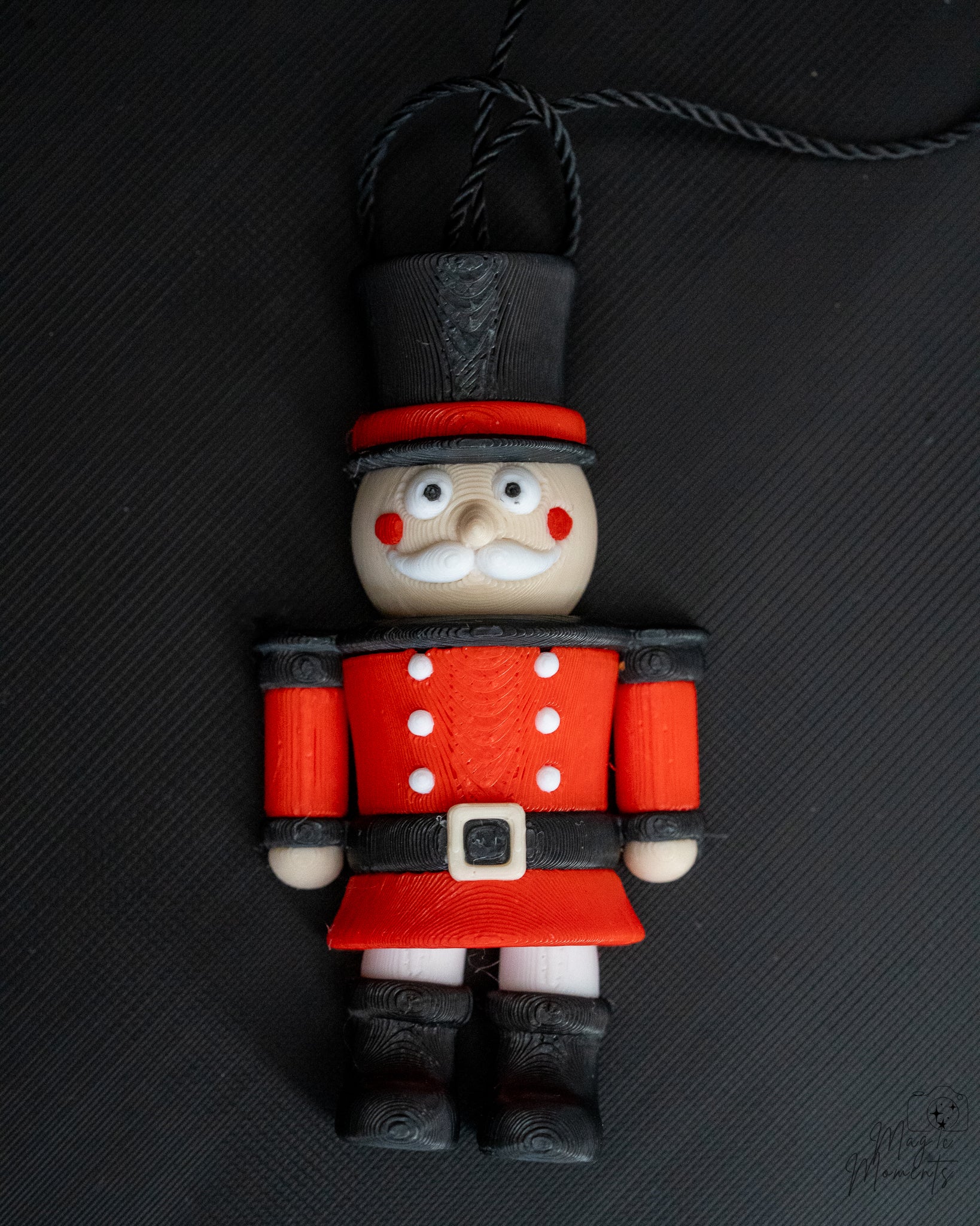 Nutcracker Christmas ornament next to measuring tape for scale