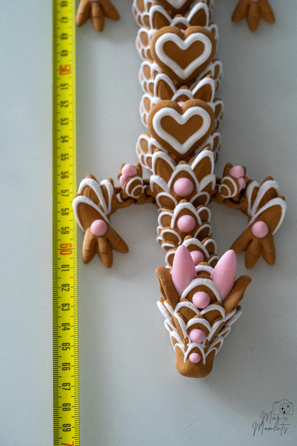 valentine dragon next to measuring tape for scale