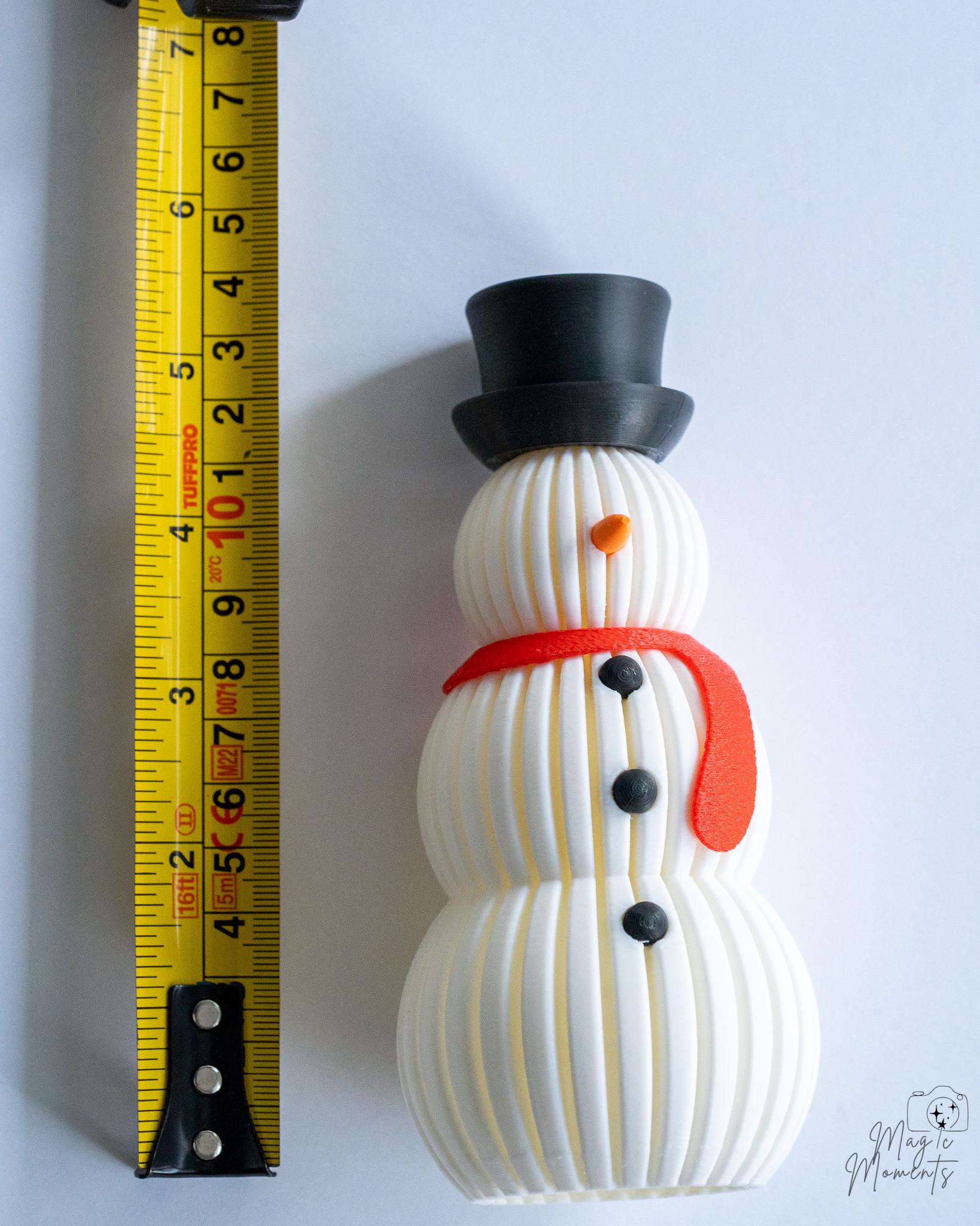 Snowman decoration next to measuring tape for scale