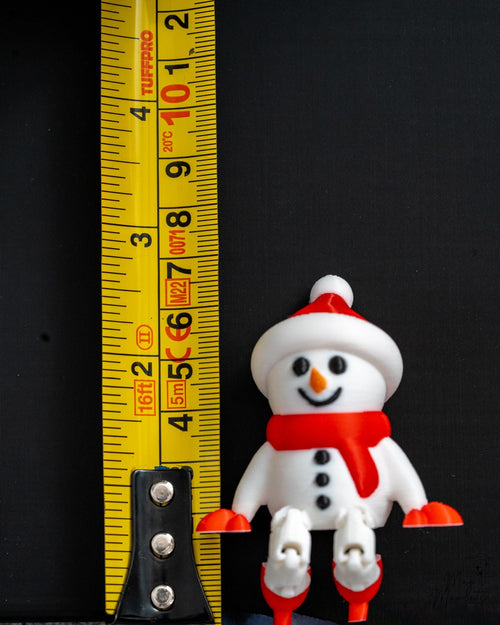 Snowman shelf sitter next to measuring tape for scale