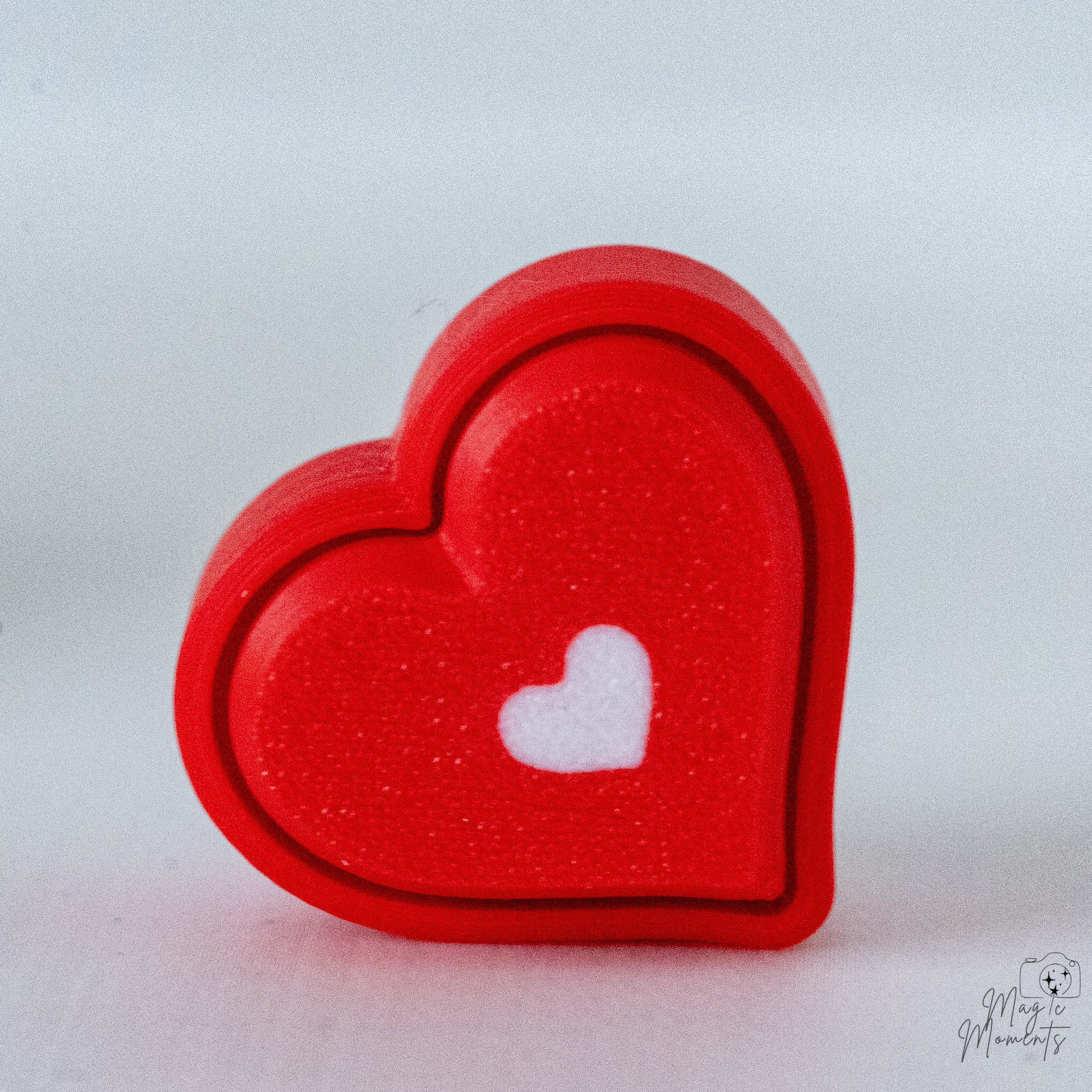 Heart clicker with small white heart detail