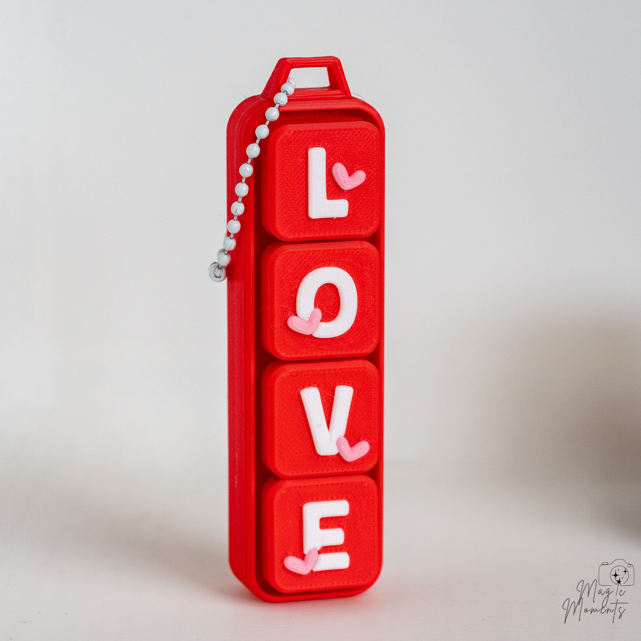 LOVE keychain clicker with hanging loop and articulated design