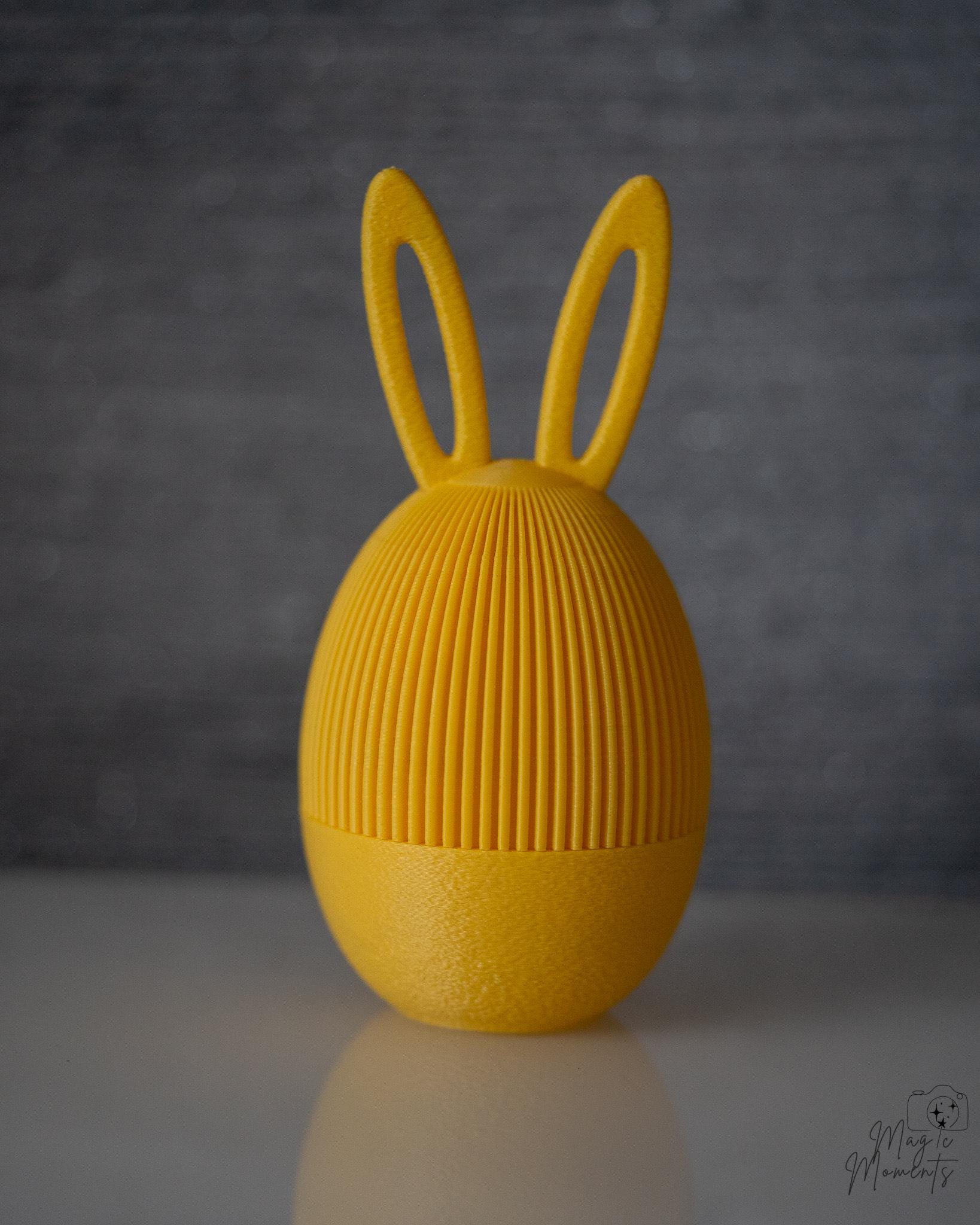 Yellow bunny ear Easter egg container with Easter themed design
