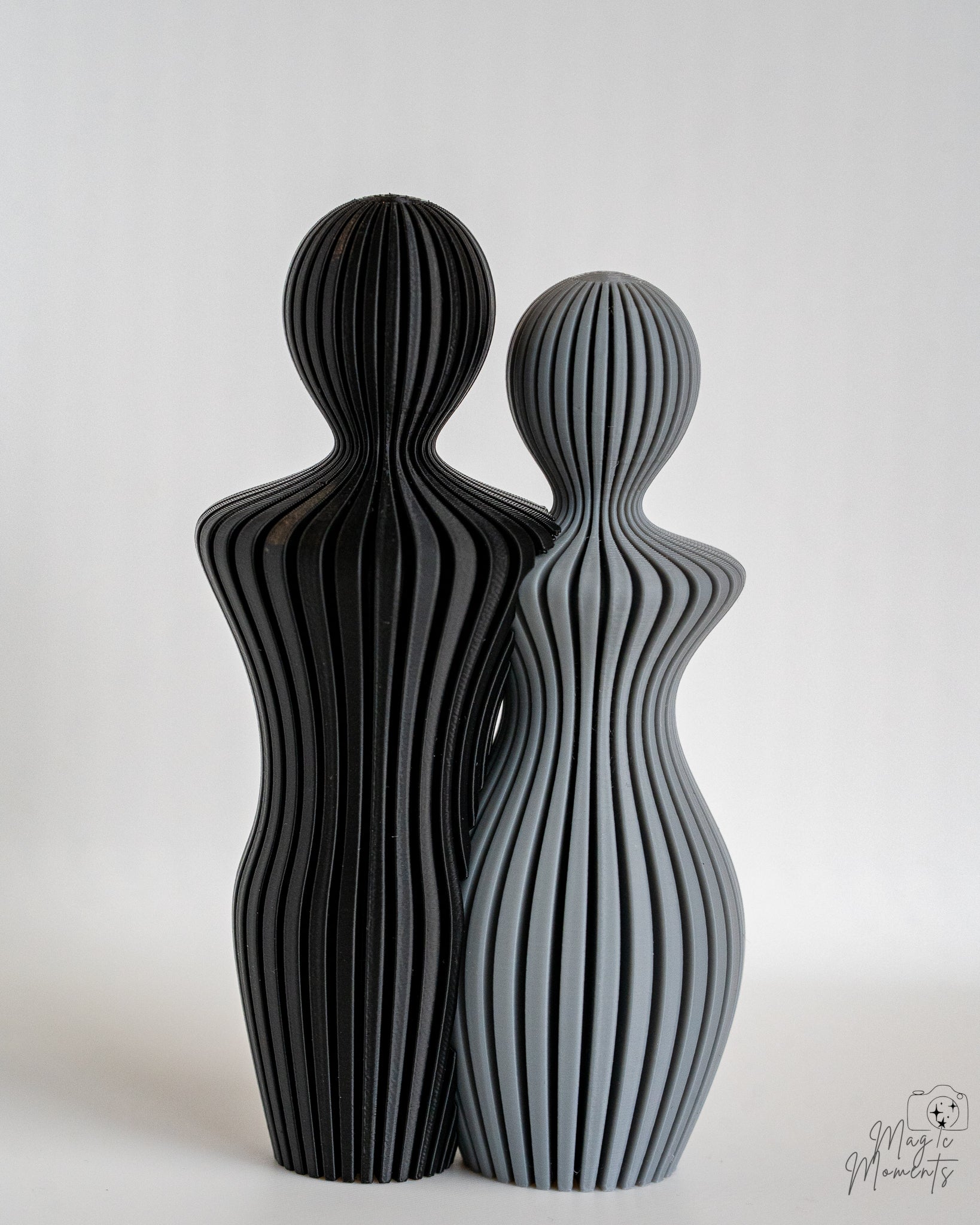 Grey and black abstract couple sculpture with minimalist aesthetic