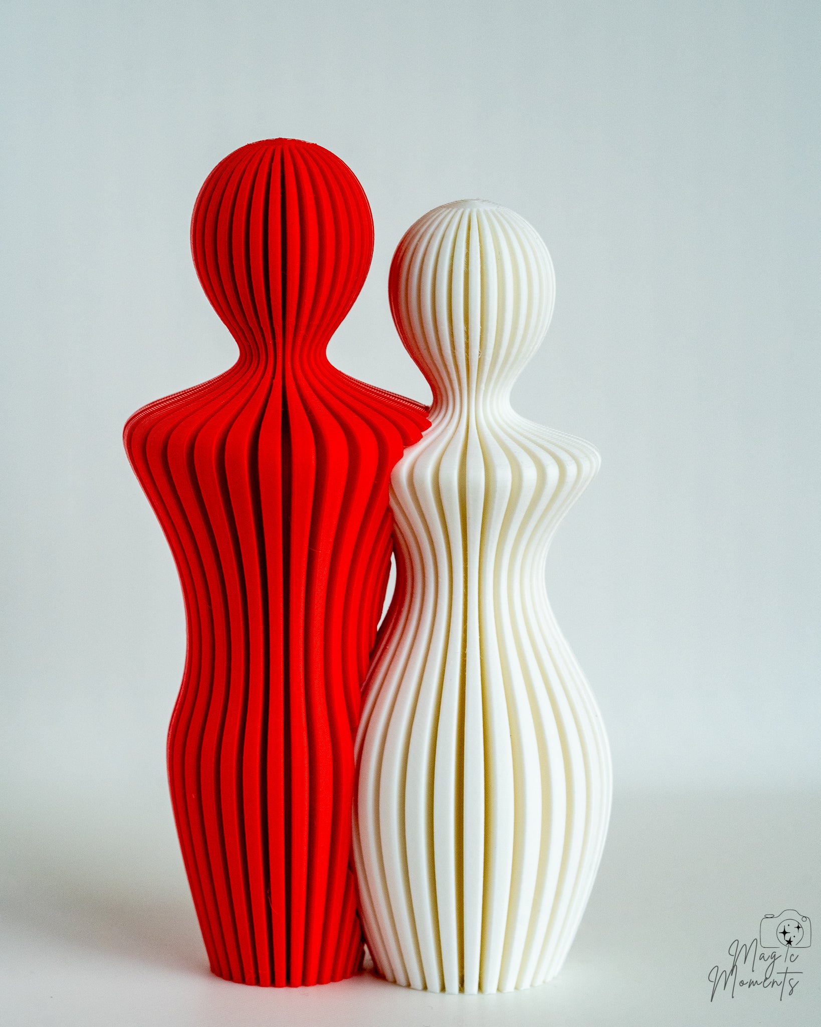 Red and white abstract couple sculpture with contrasting colours