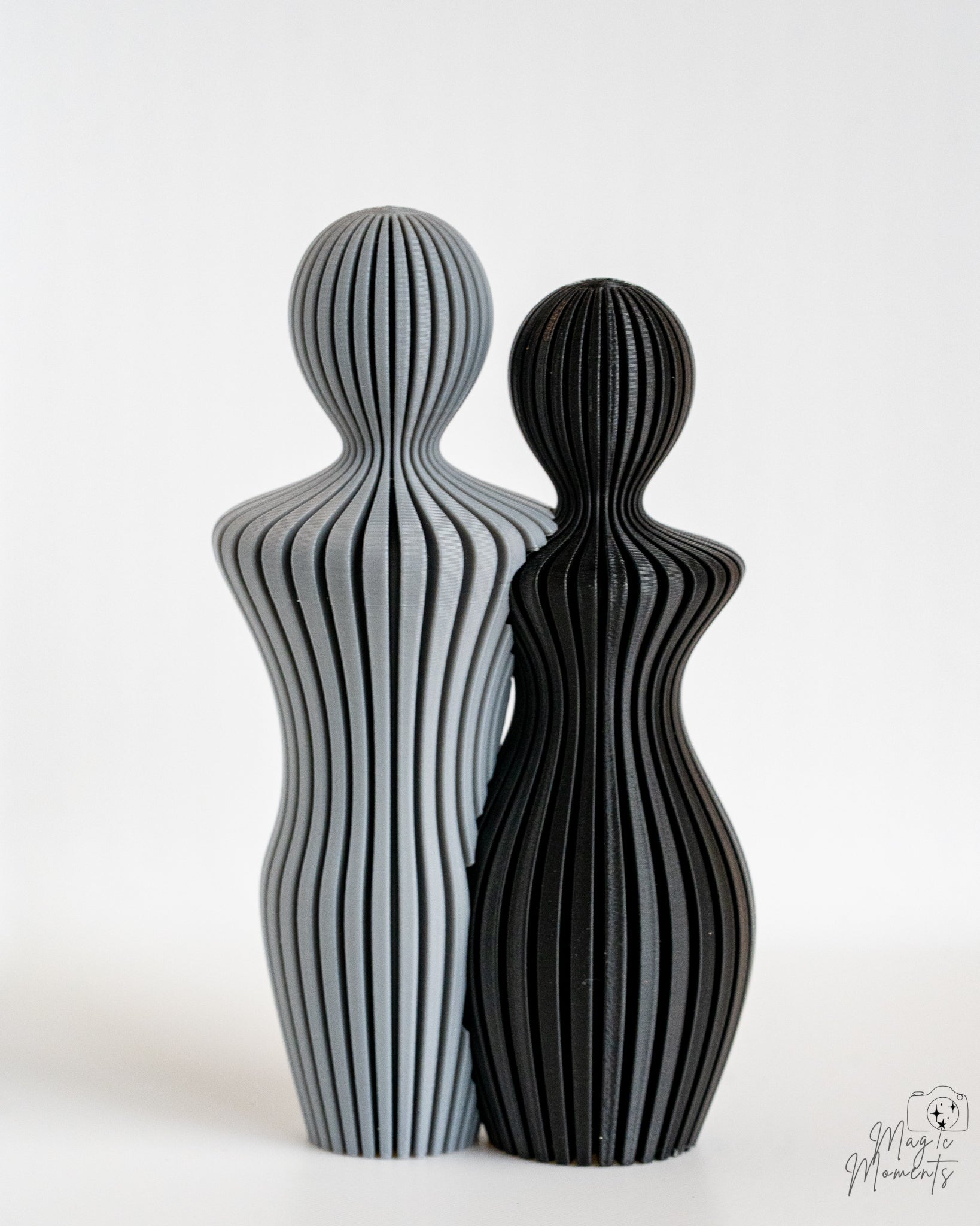 Grey and black abstract couple sculpture with minimalist aesthetic