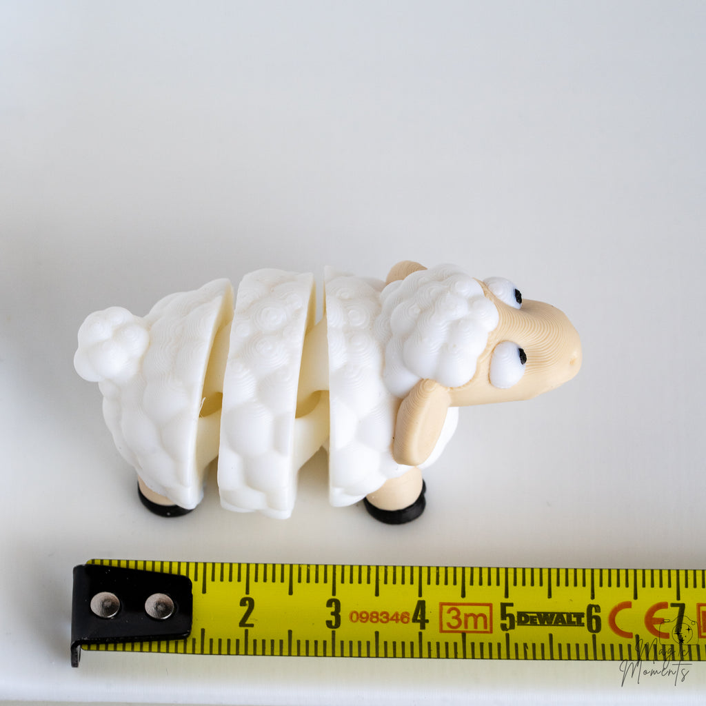 sheep figurine next to measuring tape for scale