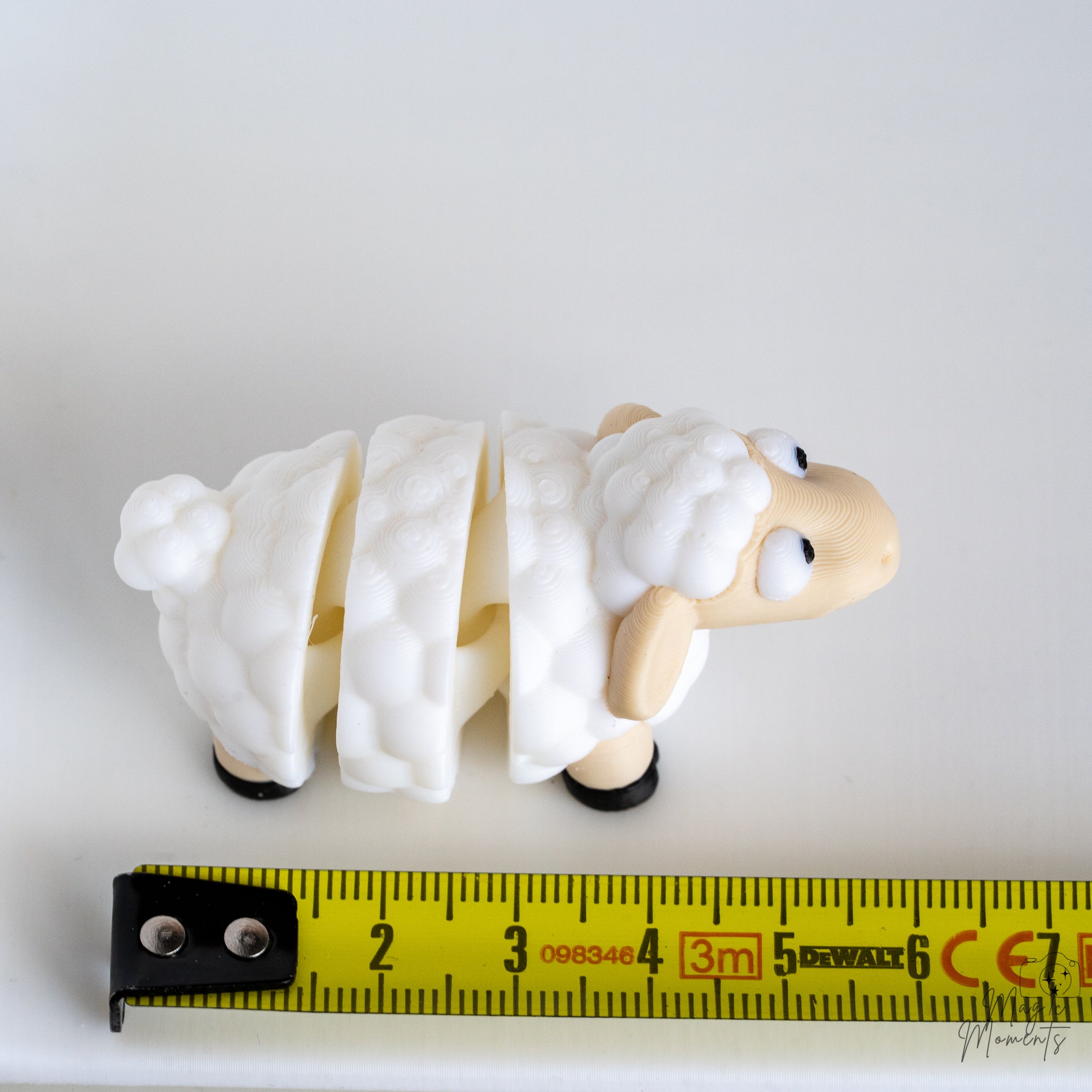 sheep figurine next to measuring tape for scale