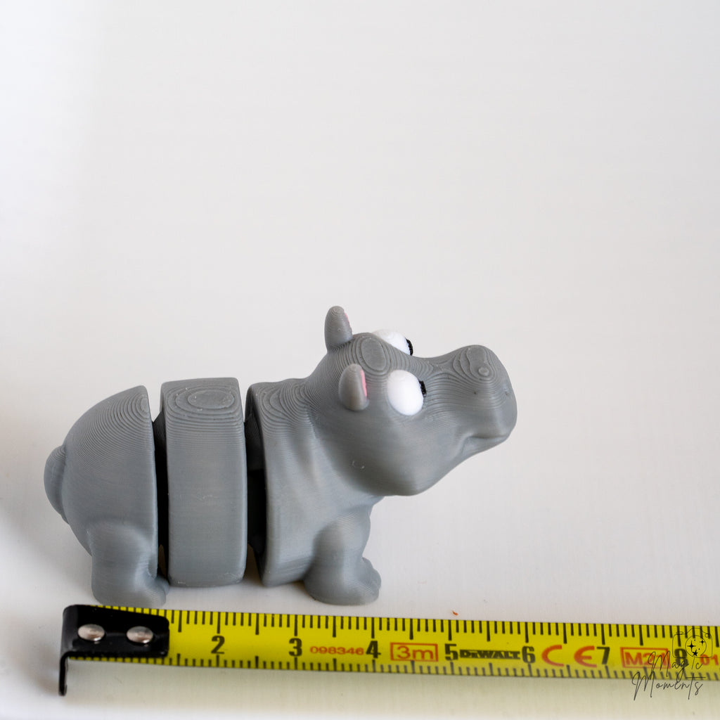 Hippo figure next to measuring tape for scale