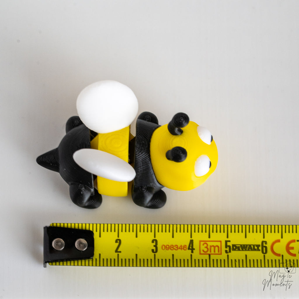 Bee figure next to measuring tape for scale
