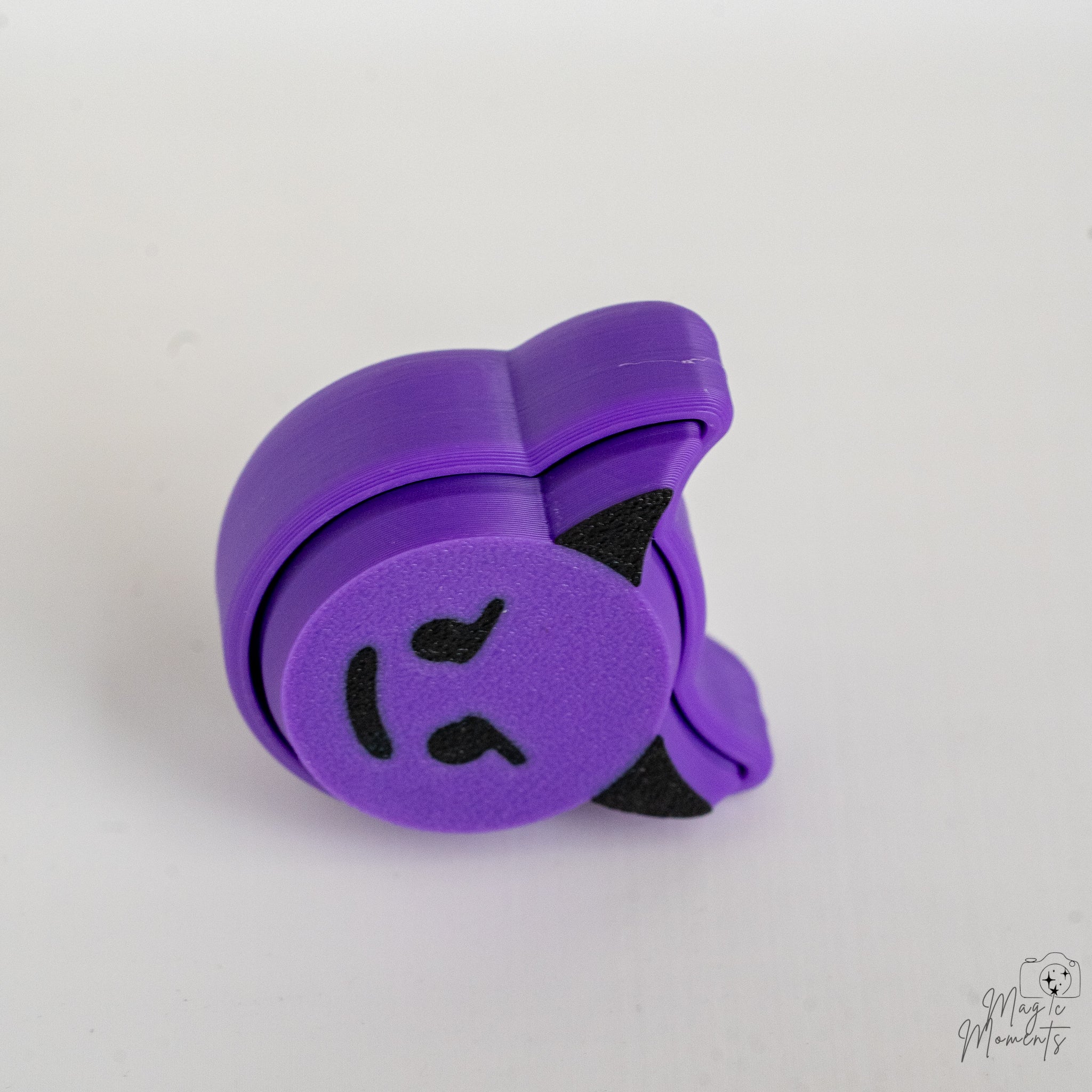 3d printed devil emoji fidget clicker side view